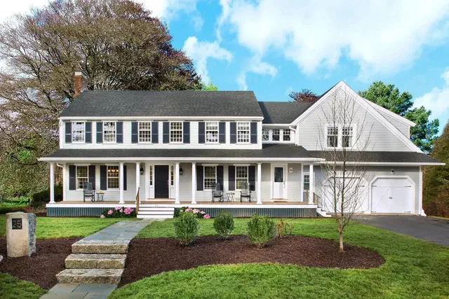 The Garrison Colonial (1935-1975) is a Colonial Revival sub-style with a second story that overhangs the first — a borrowed motif from 17th-century English-overhang houses, mass-produced for postwar subdivisions.