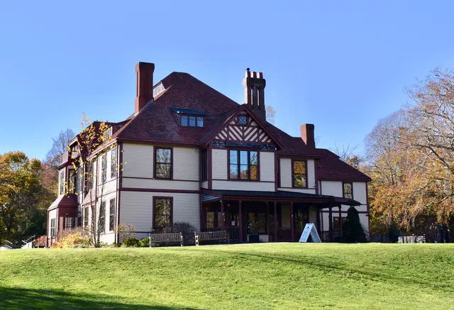 Queen Anne (1880-1910) is the most exuberant Victorian style — towers, turrets, wraparound porches, multi-textured walls. Massachusetts streetcar suburbs are full of them.