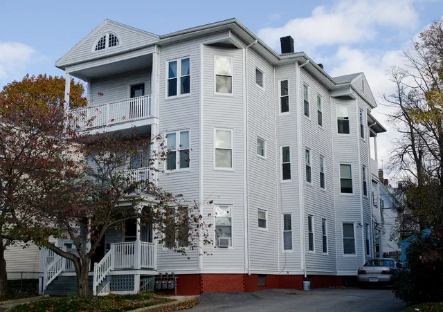 The Triple Decker (1880-1930) is New England's iconic urban multi-family housing — three full apartments stacked vertically, each with a private piazza, on a narrow city lot.